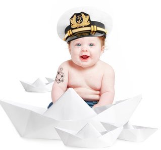 Baby in a Sailor hat showing his "first tattoo."