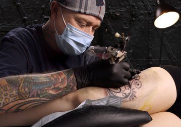 Masked Tattoo Artist